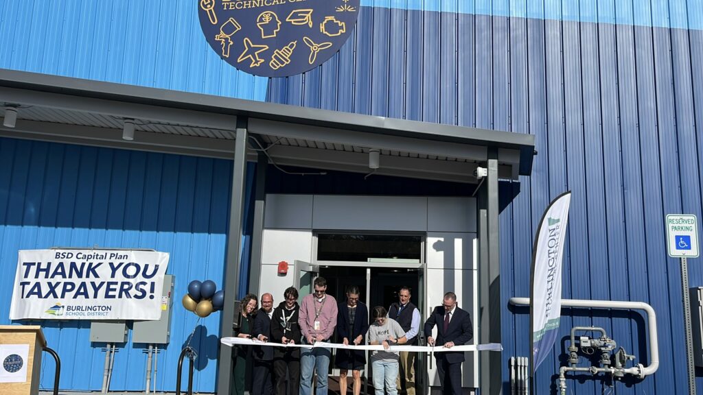 students and staff cutting ribbon