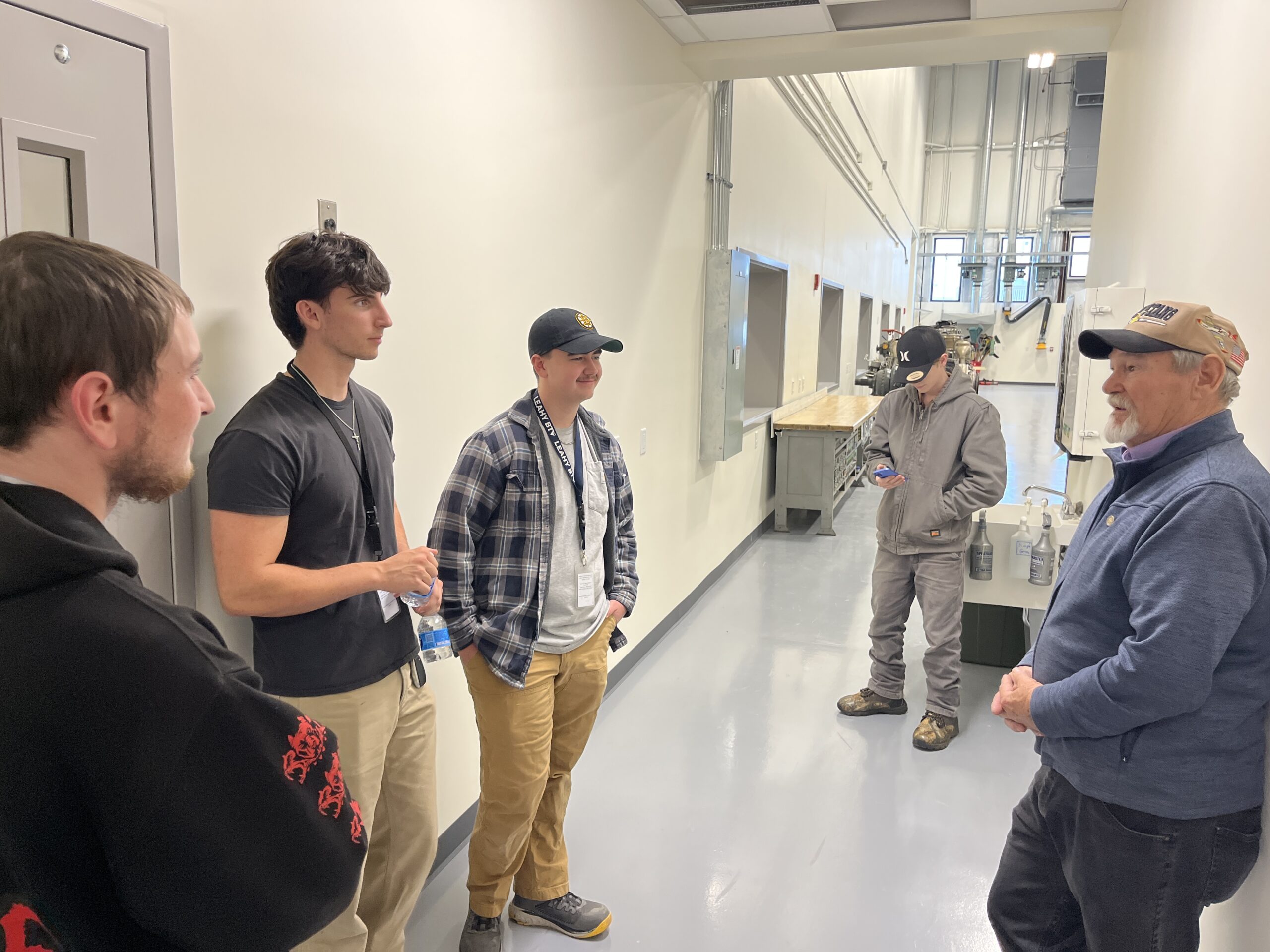 students talking to the creator of the aviation program